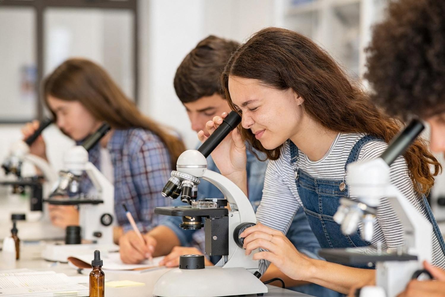 BTEC student using a microscope during a hands-on practical class